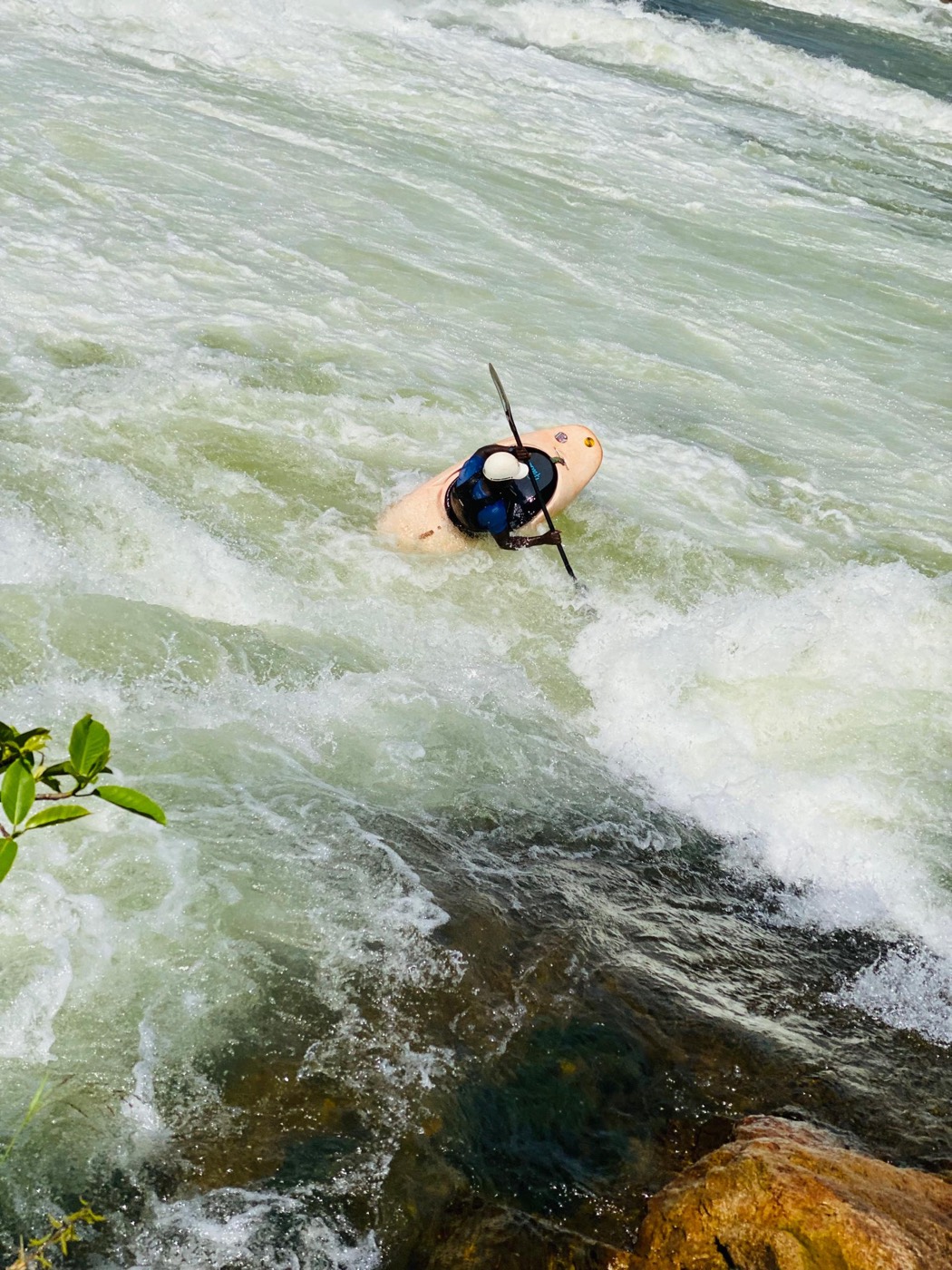 Kayaker riding the white water of the Nile